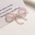 Detail of pink crystal beaded bow earring with center pearl on elegant display card - Pink