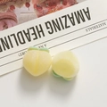 Close-up of fluffy peach resin charms with yellow flocking texture for DIY jewelry making - Yellow