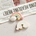 Detailed macro view of colorful flocked rainbow cloud resin charms with flat white backing - Rainbow