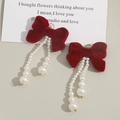 Elegant red velvet bow earrings with cascading gradient pearls in a vintage style - Red