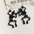 Detailed view of black skull alloy pendants with glossy front and textured back for DIY - Black