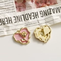 Detail of pink heart charms with gold rose relief showing front and back textures - Pink Heart Gold Rose