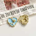 Detail of blue enamel heart charm with gold rose relief and textured back for DIY jewelry - Blue Heart Gold Rose