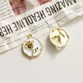 Macro view of gold-plated rose charm with white enamel and textured back for DIY jewelry - White Round Gold Rose