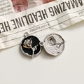 Detailed close-up of retro silver alloy rose pendant with black oil drip and relief design - Black Round Silver Rose