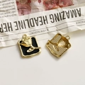 Detail of square gold tulip pendants with black enamel and honeycomb texture back - Black Square Gold Rose