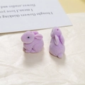 Detailed macro view of purple flocked rabbit resin charms for DIY jewelry making - Purple