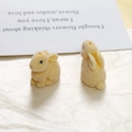 Detailed macro view of beige flocked bunny resin charms for DIY jewelry and hair accessories - Yellow