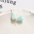 Close-up of blue gradient lily flower bead with golden hook for DIY jewelry making - Light Blue