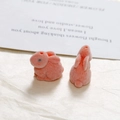 Close-up of pink flocked rabbit charms showing soft fuzzy texture and DIY threading holes - Red