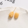 Macro detail of tulip-shaped cream resin pendant with gold metal pin for DIY jewelry making - Tulip Bud (61#) / 1 Piece / Light Yellow