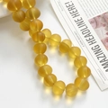 Macro view of matte translucent yellow frosted glass beads for DIY jewelry making crafts - 1 Piece / Yellow