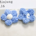 Close-up of blue chenille crochet puff flower accessories for DIY jewelry and hair clips - Blue