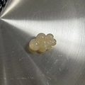 Close-up of semi-transparent yellow cloud bead with hole for DIY jewelry making - Cloud Shape / Marbled Beige