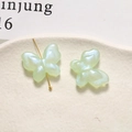Detailed view of light green butterfly acrylic beads with sparkling pearlescent texture - 1 Piece / Green