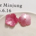 Close-up of pink pearlescent acetate flower beads with realistic petal texture and holes - Rose Red