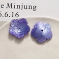 Detailed macro view of purple flower acrylic bead with shimmer texture and central hole - Purple