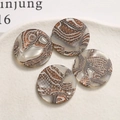 Macro shot of circular brown marble acetate charms for jewelry making and DIY crafts - 1 Piece / Deep Brown (Mineral Texture)