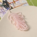 Detailed macro view of handmade pink beaded flower charm with golden metal jump ring - Pink