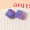 Macro shot of 16mm square resin charms with blue-purple marble smoke and gold glitter - Purple