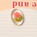 Macro shot of oval resin cabochon with pink rose and green leaves for DIY crafts - Deep Pink (One Piece)