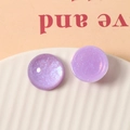 Macro shot of 20mm purple translucent glitter resin cabochons for DIY jewelry making - Purple