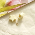 Macro shot of a cream acrylic star bead with gold metal pin for jewelry making - 1 Piece / Yellow