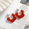 Detail of red translucent resin flower earrings with imitation pearl studs on magazine - Red Flower One Piece
