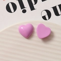 Lavender purple heart-shaped resin charms displayed on a white ceramic wavy tray - Purple