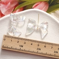 Close-up of translucent aurora resin bow charms with measuring ruler for jewelry DIY - Aurora Bowknot Style 1 (2)
