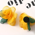 Close-up of yellow layered organza rose petals with green mesh leaves for DIY crafts - Yellow
