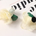 Detail of cream organza fabric flower accessory with green leaves for hair ornaments - White