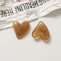 Détail macro de breloques en résine en forme de cœur avec texture marbrée marron polie - Ambre