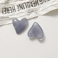 Macro detail of heart-shaped resin charms with smoke marble texture for DIY jewelry - Grey Purple
