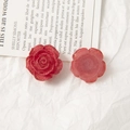 Close-up of red acrylic rose accessories with vintage distressed gold edges for DIY jewelry - Red