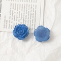 Macro detail of blue rose acrylic DIY charms showing front petals and matte back - Blue