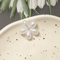 Macro view of pearlescent five-petal flower beads on a ceramic dish for DIY jewelry - Mermaid Iridescent Five-Petal Flower / 1 Piece / AB White