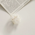 Detail of delicate white organza flower accessory with golden beaded core and petals - White