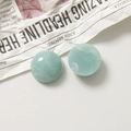 Detailed macro view of green marble-patterned resin dome beads on a paper background - Semicircle / Blue