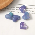 Macro shot of marble textured resin heart charms with a glossy purple and blue gradient finish - Starry Purple