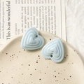 Gros plan détaillé de breloques en forme de cœur bleu clair sur un plateau pour bijoux DIY - Bleu