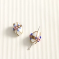 Detailed macro shot of oval white glass beads with hand-painted gold and pink floral accents - Olive Shape (96#) / 1 Piece / White