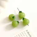 Macro detail of handmade pear-shaped glass beads for DIY jewelry with green leaf accents - 1 Piece / Green