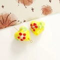 Dettaglio macro di perla in vetro a cuore giallo con decoro floreale per gioielli DIY - Giallo