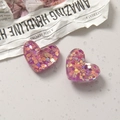 Macro shot of heart-shaped glittery resin charms for DIY jewelry and phone case making - Rose Red