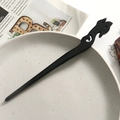 Close-up of a carved black sandalwood hair pin placed on a vintage ceramic plate - Phoenix Shaped Hollow Style (6)
