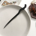 Detail of a wave-shaped black sandalwood hair stick placed on a ceramic plate - Simple Wave Curve Style (8)