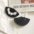 Close-up of black fan-shaped acrylic jewelry charms with white 3D rose flower details - Solid Black