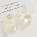 Macro detail of bear-shaped hair clips with iridescent finish on a white prop card - Sitting Bear