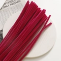 Macro detail of plush velvet crafting pipe cleaners in deep red for DIY jewelry making - Rose Red